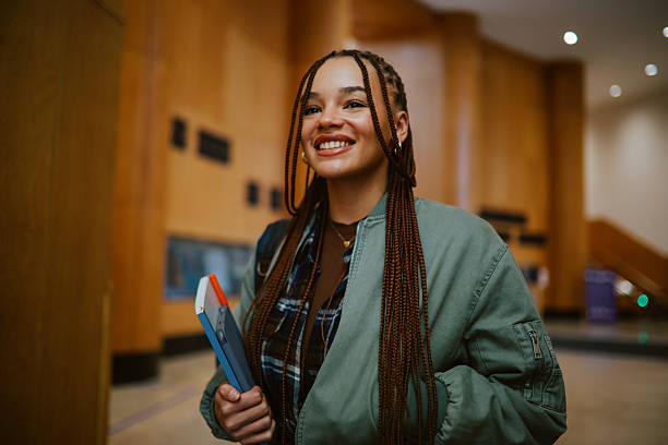 Student smiling in a modern campus hallway